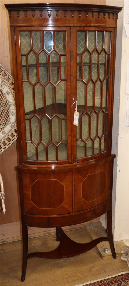 An Edwardian inlaid mahogany bow fronted corner cupboard W.61cm